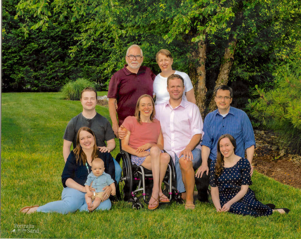 Photo of Cindy and John Kolbe with their three children, three spouses, and a baby boy.