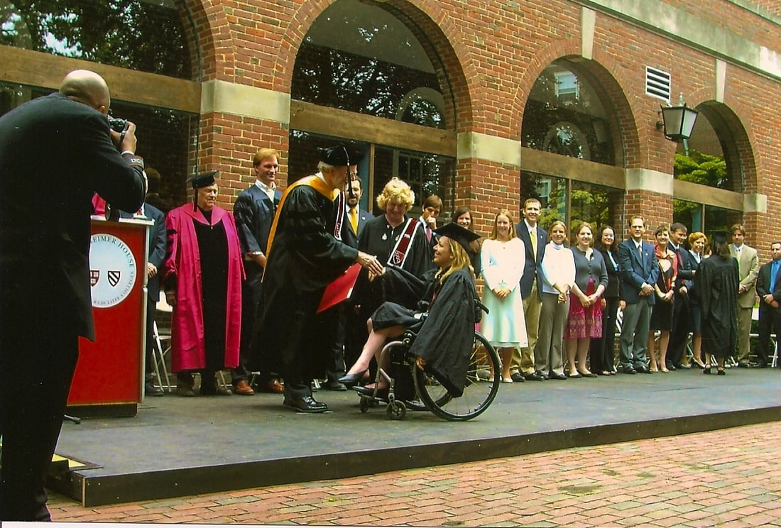 Photo of Beth in a graduation gown and cap at Harvard, shaking the hand of a robed professor.